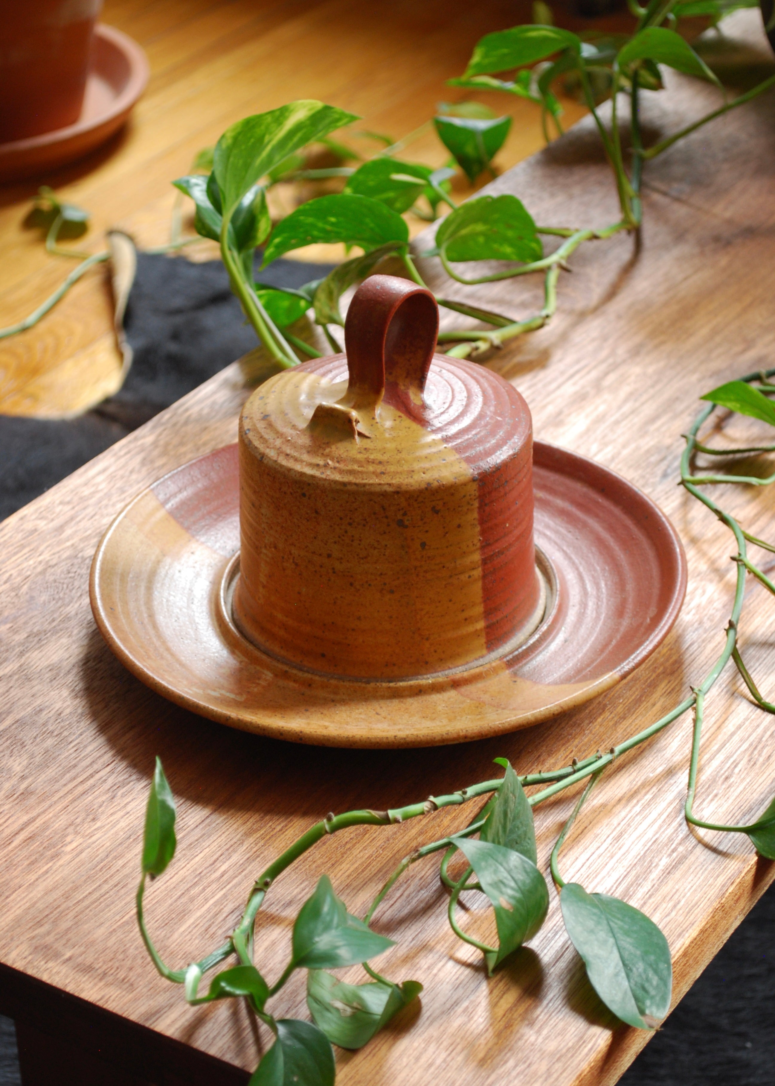 Hand spun ceramic cheese or dessert platter in orange and red glaze and natural clay.