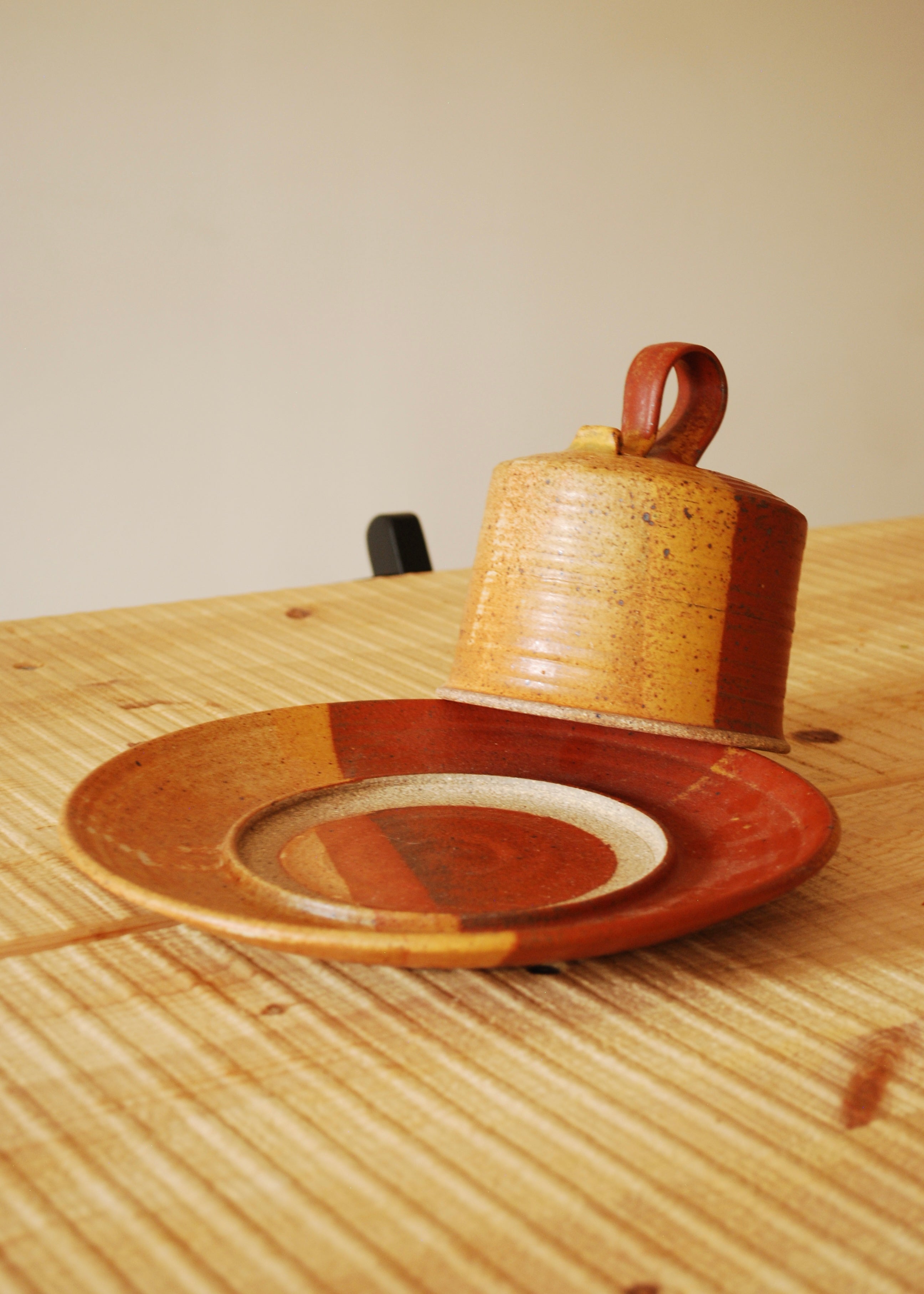 Hand spun ceramic cheese or dessert platter in orange and red glaze and natural clay.