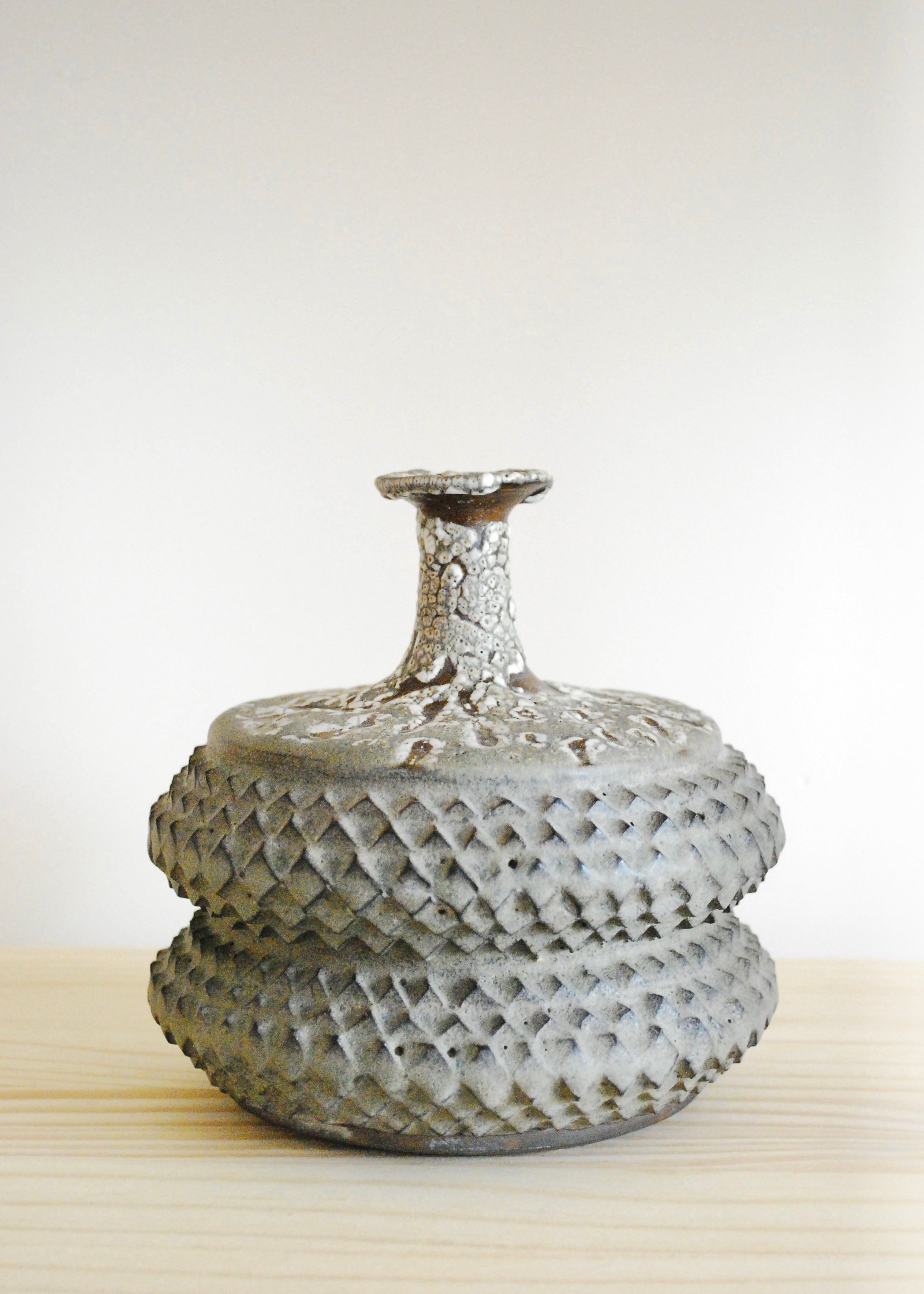 Handmade tramp art ceramic vase vessel with texture throughout and speckled glaze