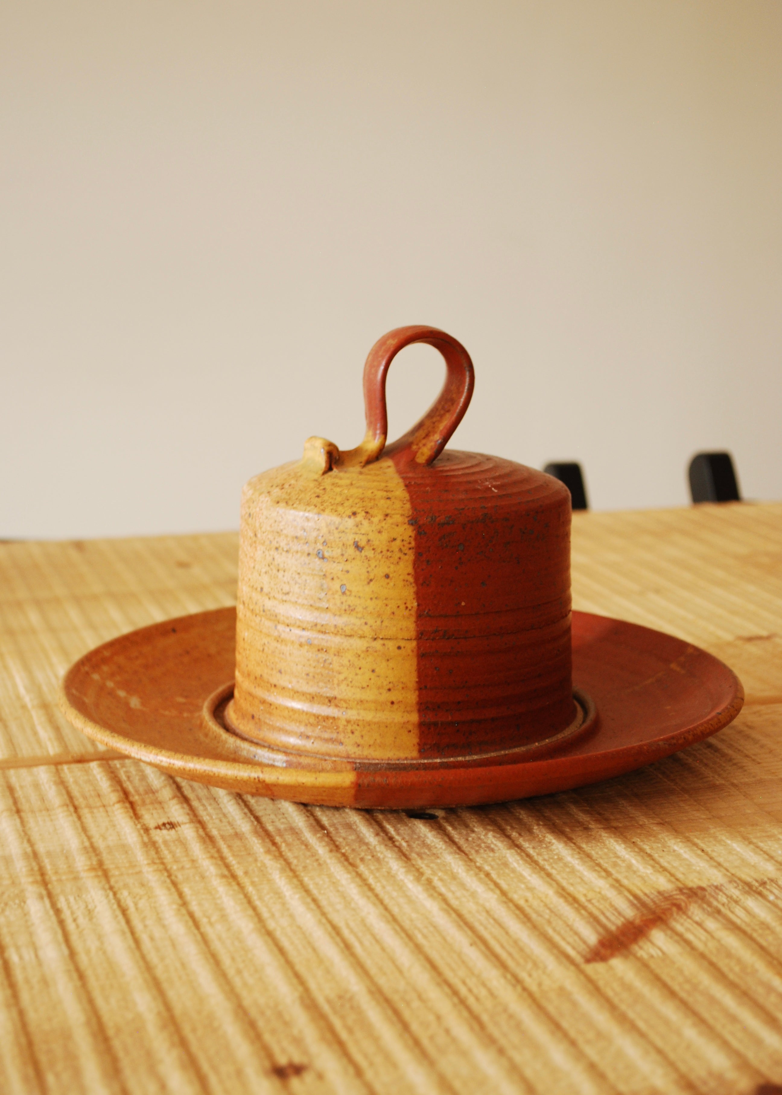 Hand spun ceramic cheese or dessert platter in orange and red glaze and natural clay.