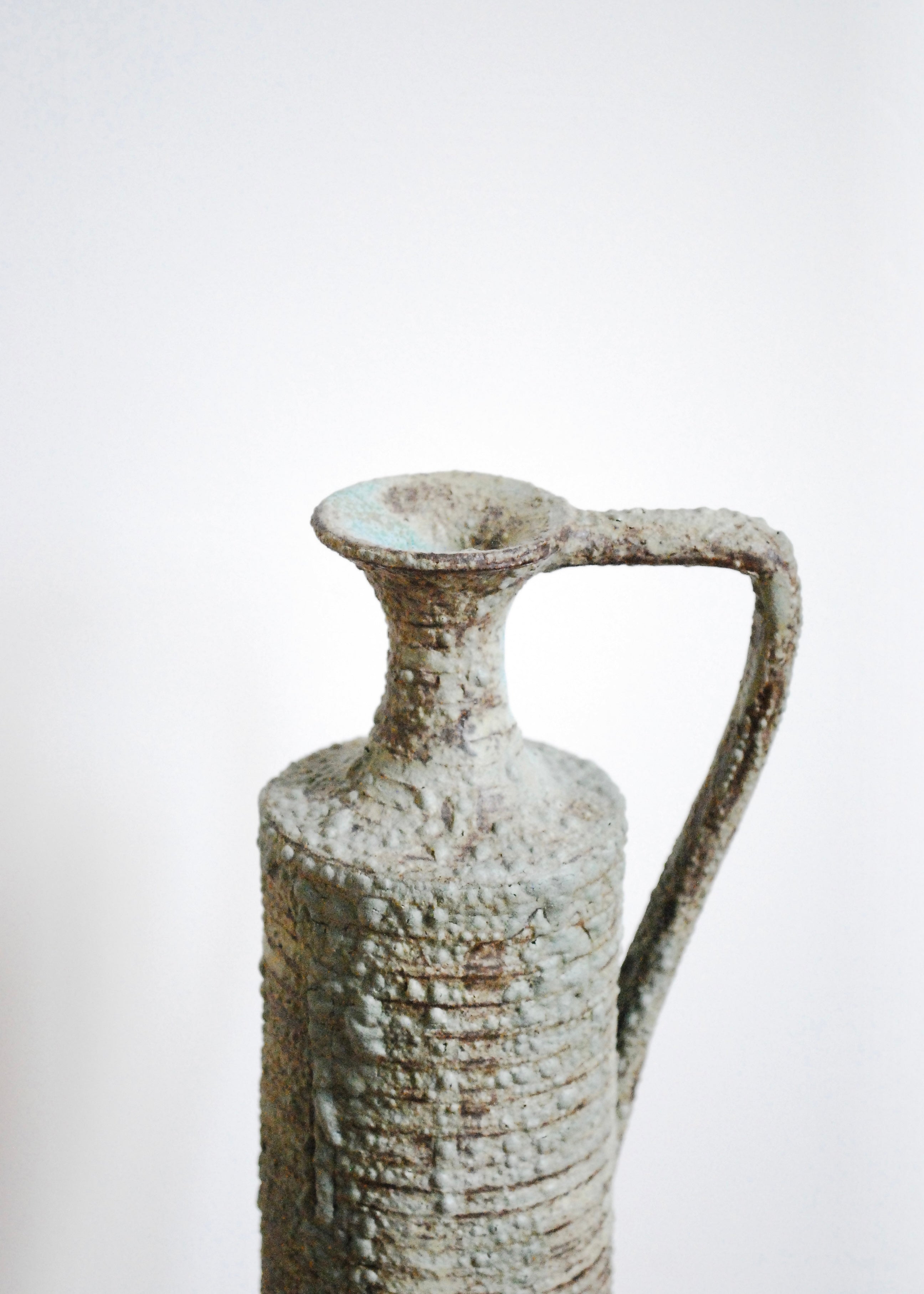 Ornate handmade ceramic pitcher jug with handle and textural worn glaze in Sea foam and gray