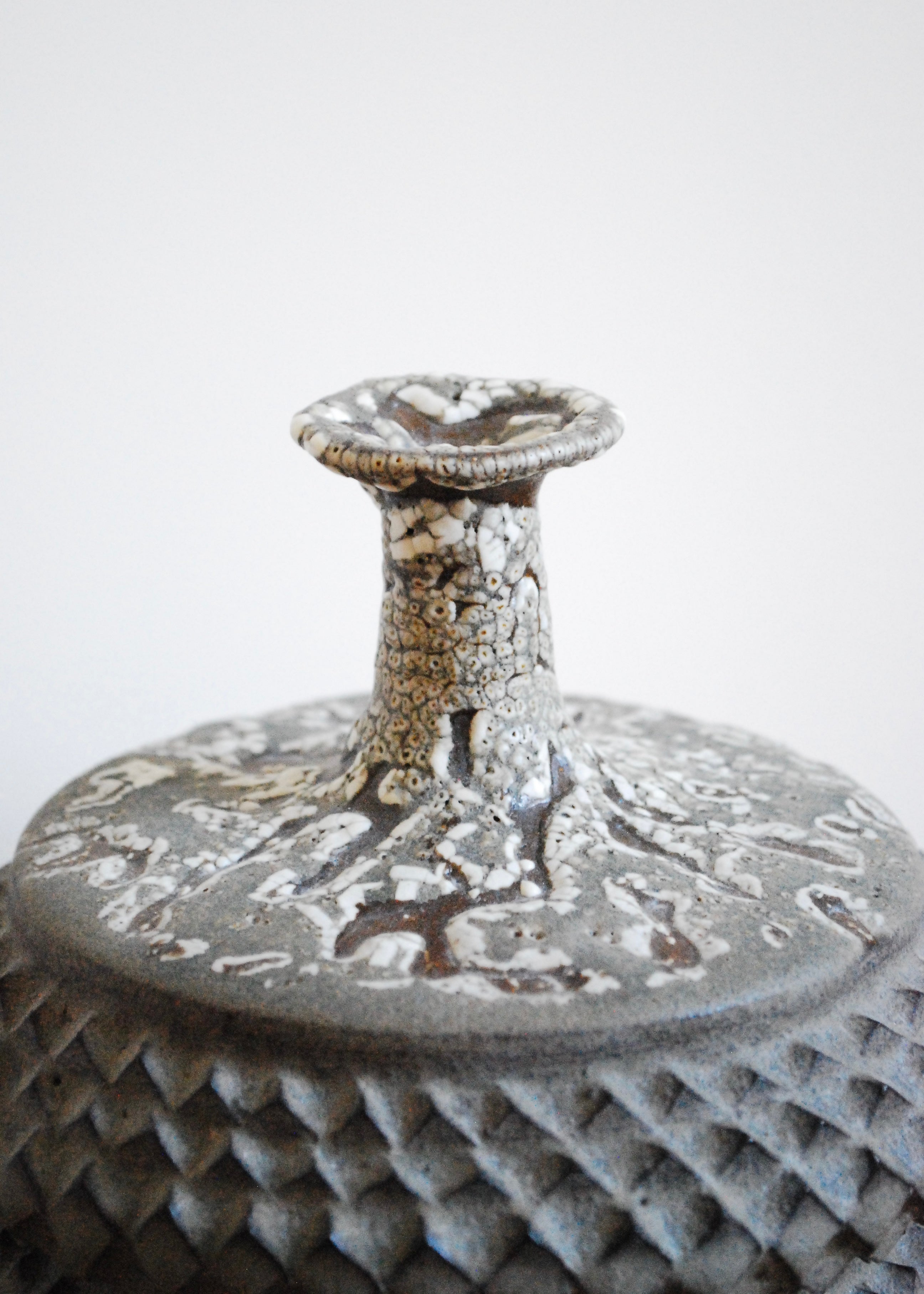 Handmade tramp art ceramic vase vessel with texture throughout and speckled glaze