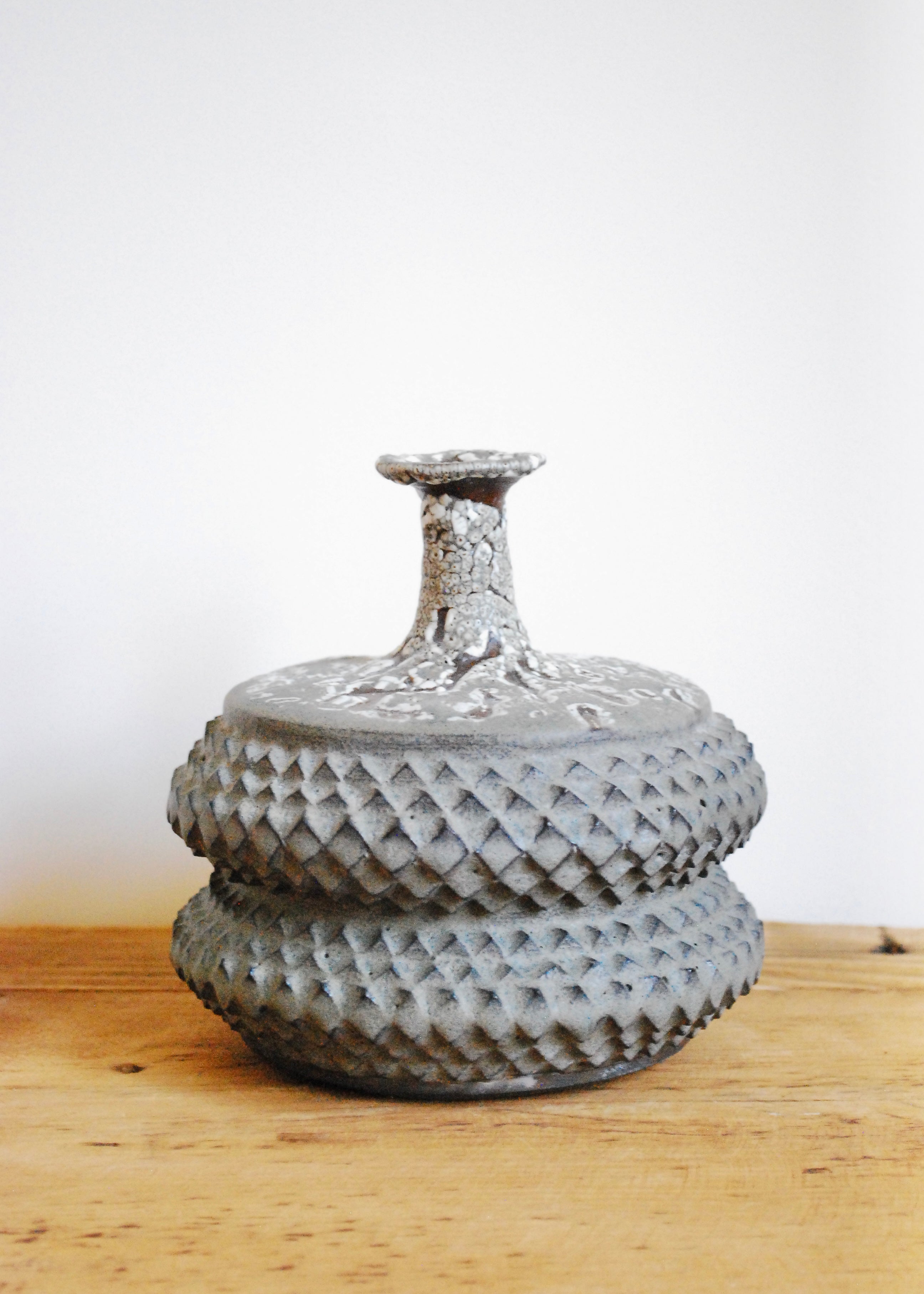 Handmade tramp art ceramic vase vessel with texture throughout and speckled glaze