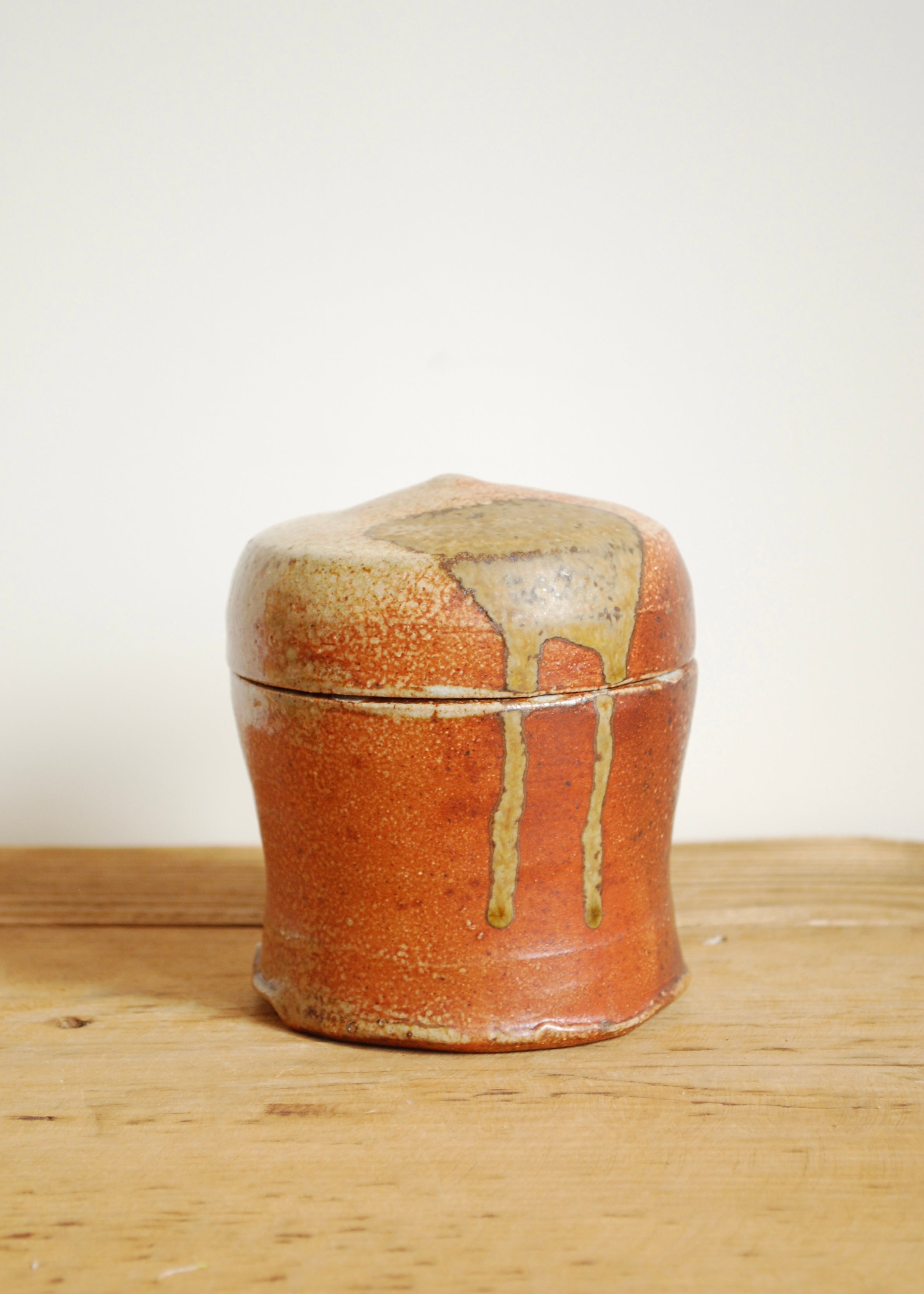 Handmade sculpted and thrown ceramic vessel in natural clay and brick glaze