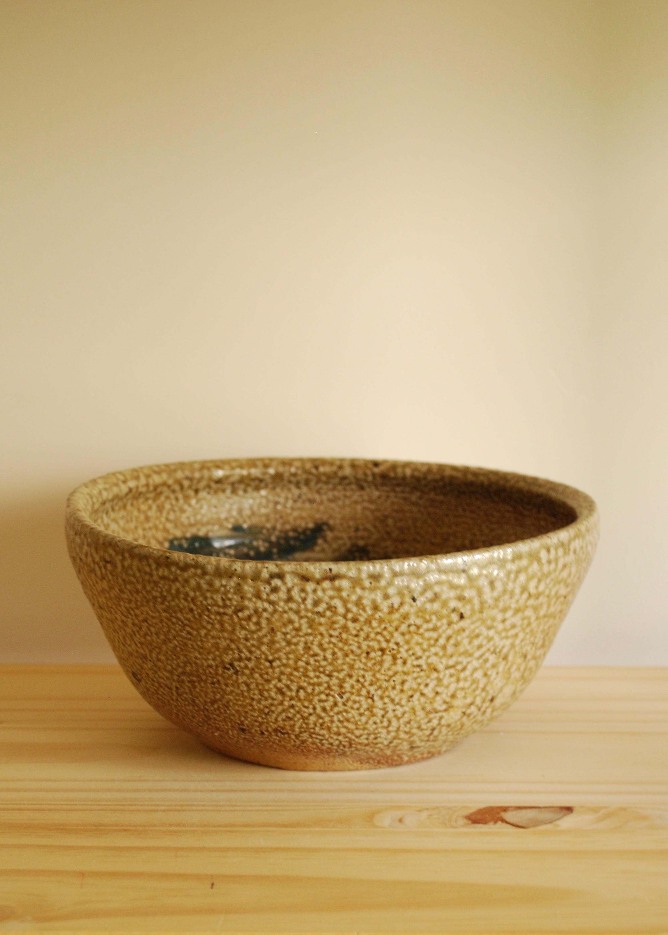 Ceramic bowl with textured surface on a wooden surface