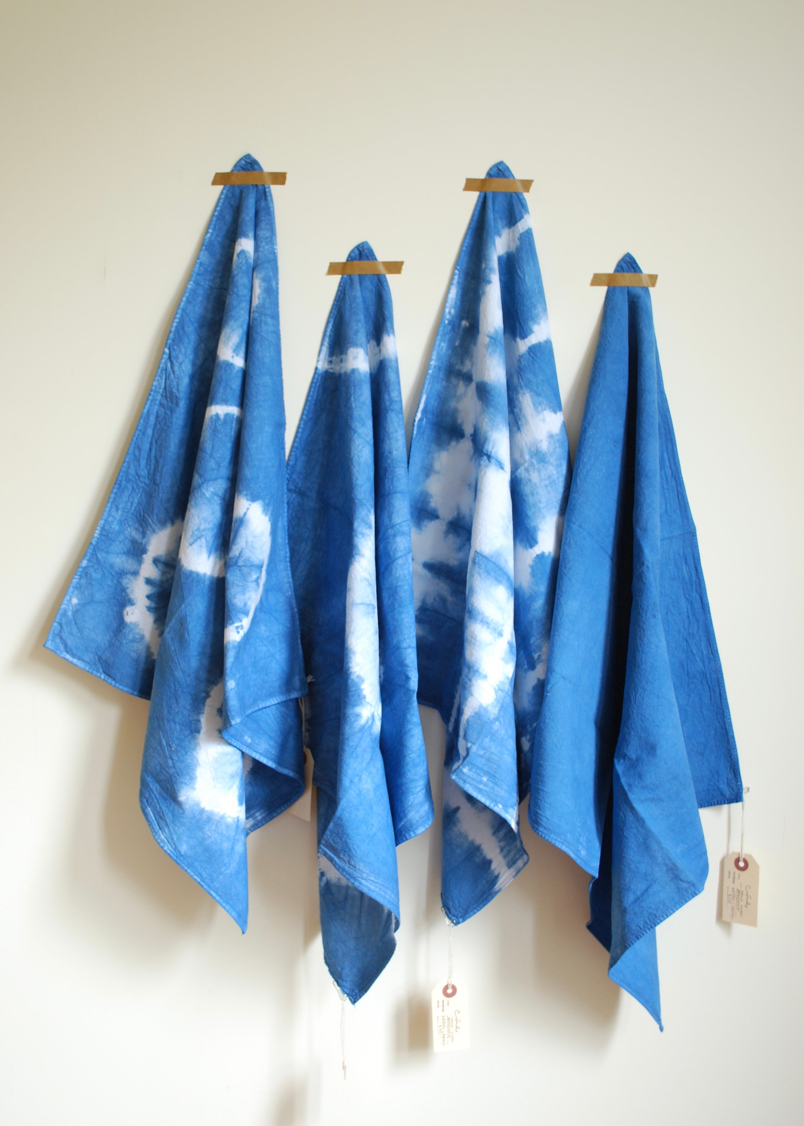 Natural indigo hand dyed organic cotton bandanas in solid and shibori patterns